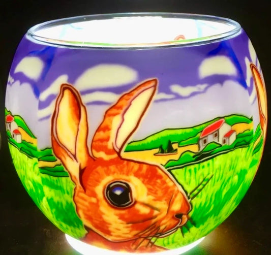 The Farmer's Fields Claymaster light globe glowing with a large rabbit before green farm fields, white farmhouses and a purple sky