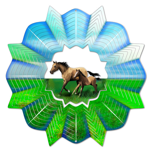 Large round wind spinner showing a tan mare and foal galloping through a green meadow, framed by layered chevron-cut blades